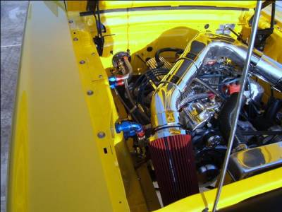 We the shaved the original shock towers, welded custom ribbed panels flush with the original inner engine panels and painted the engine compartment yellow to match the exterior.